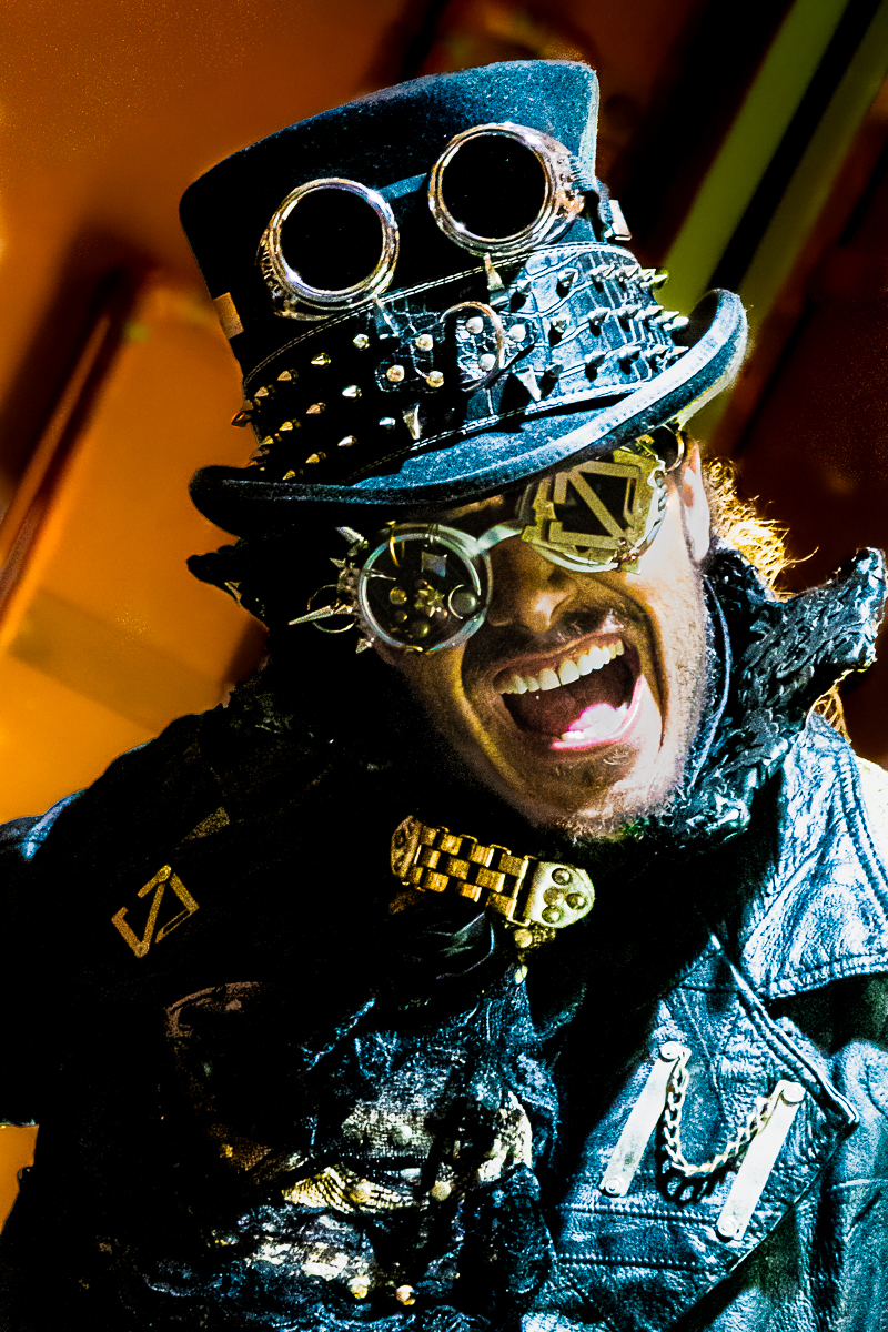 Steampunk cosplayer full length — top hat, cane, and Victorian-industrial styling